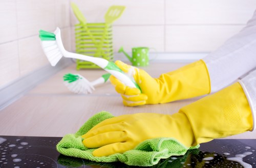 Professional cleaner following safety procedures in a property